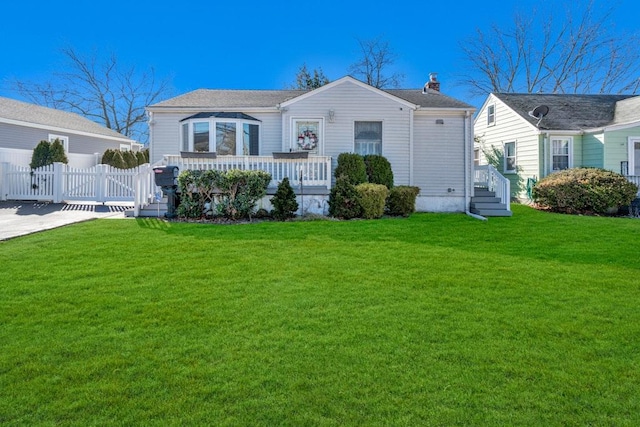 view of front of property featuring a front lawn, a chimney, fence, and a gate