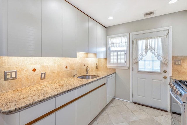 kitchen featuring visible vents, white cabinets, a sink, gas range, and dishwasher