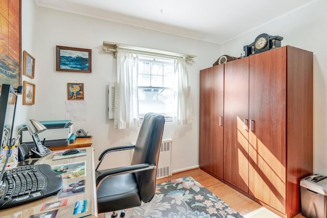 office featuring light wood-type flooring, radiator, and ornamental molding