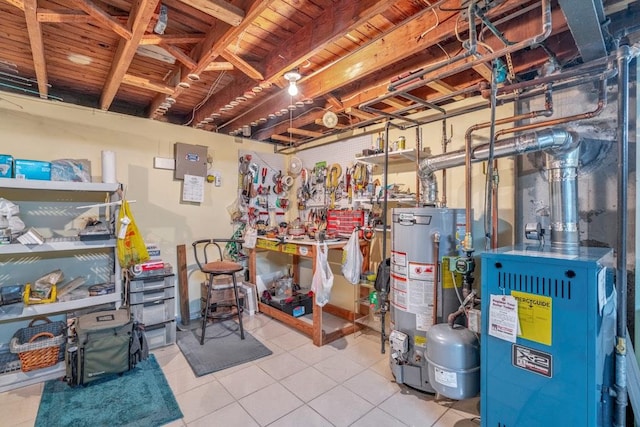 interior space with a heating unit, tile patterned flooring, water heater, and a workshop area