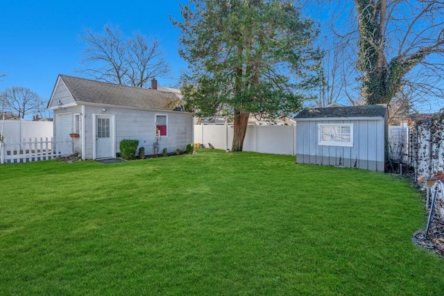 view of yard featuring an outdoor structure and a fenced backyard