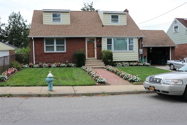 cape cod house with an attached garage, brick siding, a shingled roof, a chimney, and a front yard