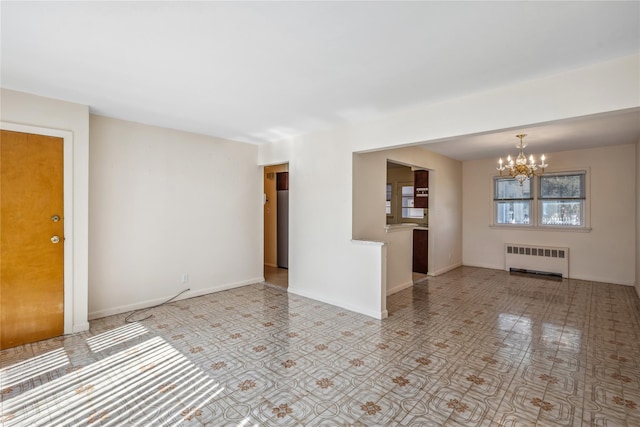 unfurnished room with radiator heating unit, a chandelier, and baseboards