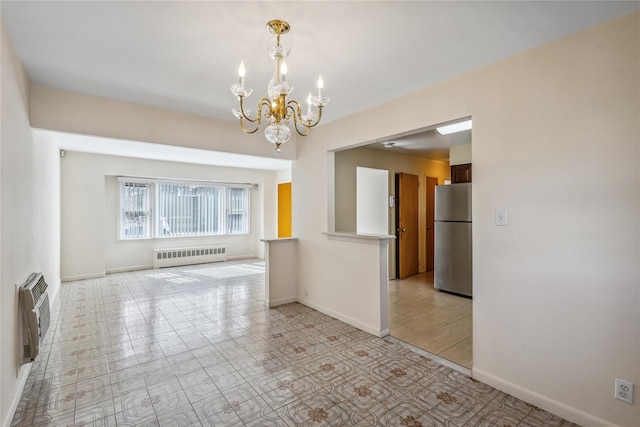 spare room with a chandelier, an AC wall unit, baseboards, and radiator