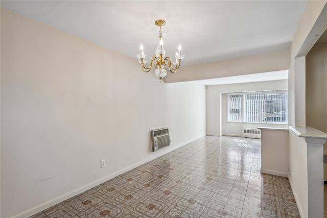 unfurnished living room featuring baseboards, an inviting chandelier, heating unit, and radiator