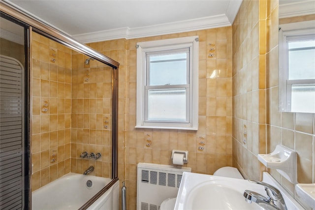 bathroom with crown molding, a sink, tile walls, and radiator heating unit