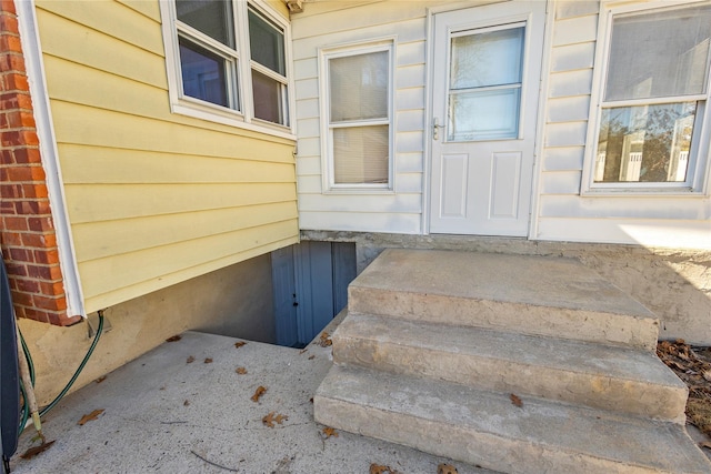 view of exterior entry featuring brick siding