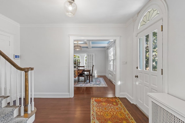 foyer featuring dark wood-type flooring, coffered ceiling, baseboards, and stairs