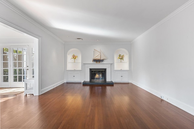 unfurnished living room featuring visible vents, dark wood finished floors, baseboards, ornamental molding, and a glass covered fireplace