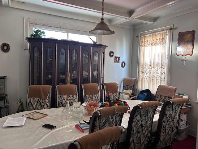 dining area with coffered ceiling and beamed ceiling