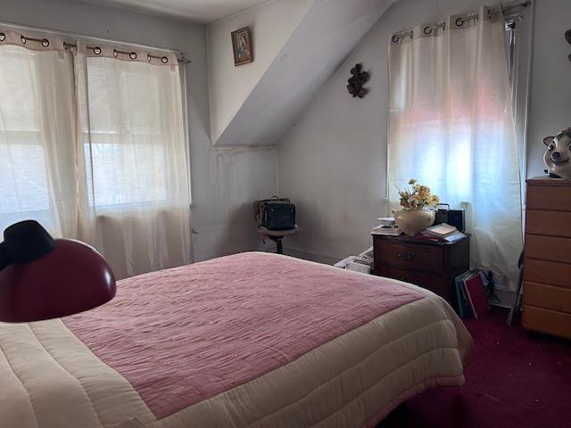 carpeted bedroom with vaulted ceiling