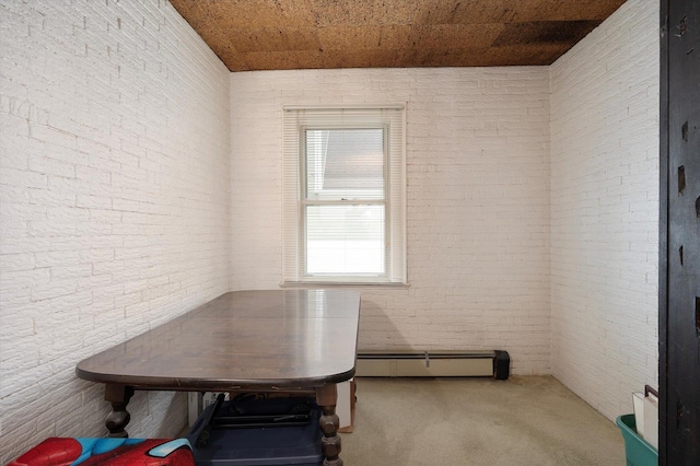 unfurnished dining area with brick wall, carpet floors, a baseboard radiator, and wood ceiling