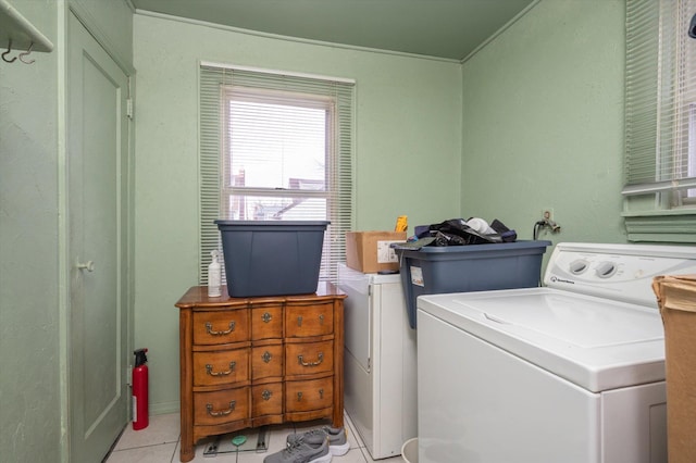 laundry room featuring light tile patterned floors, laundry area, and washer / clothes dryer