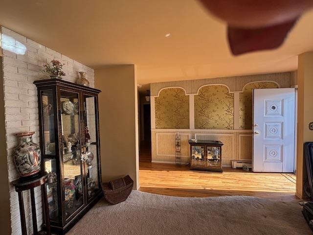 carpeted living room with a baseboard radiator