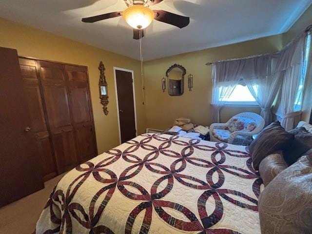 carpeted bedroom with a closet and a ceiling fan