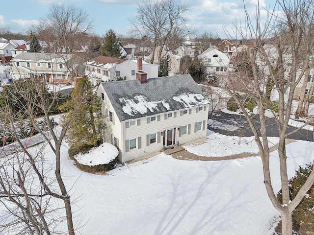 snowy aerial view featuring a residential view