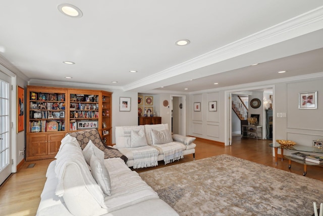 living room with recessed lighting, stairway, light wood-style floors, and crown molding