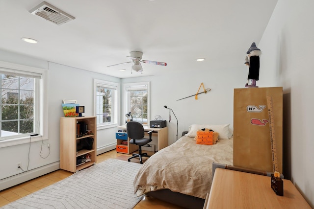 bedroom featuring light wood-type flooring, recessed lighting, visible vents, and a baseboard radiator