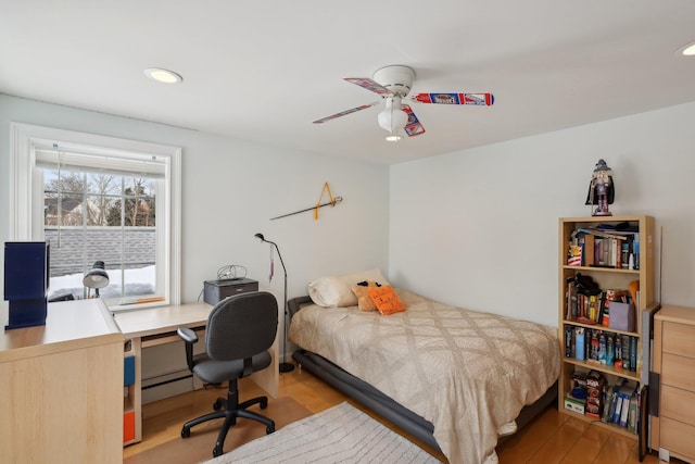 bedroom with baseboard heating, recessed lighting, light wood-style floors, and ceiling fan