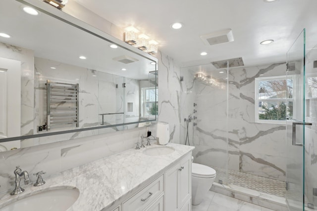 bathroom featuring a marble finish shower, marble finish floor, radiator, and a sink