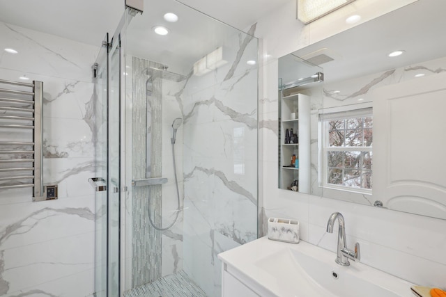 full bathroom featuring visible vents, recessed lighting, a marble finish shower, radiator, and vanity