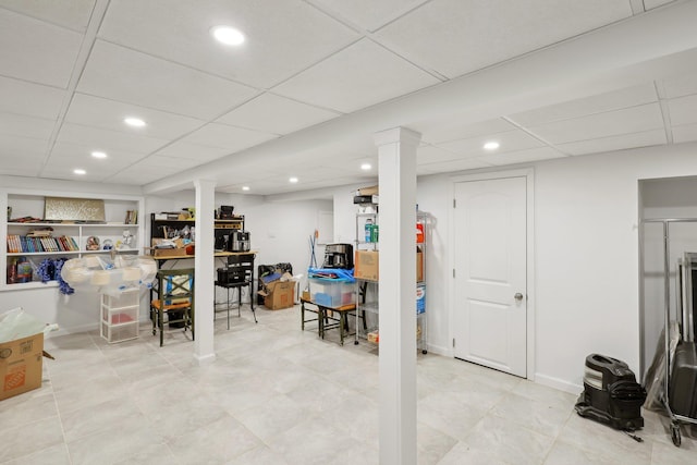 finished basement featuring recessed lighting, a paneled ceiling, and baseboards