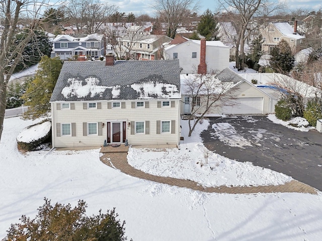 snowy aerial view with a residential view