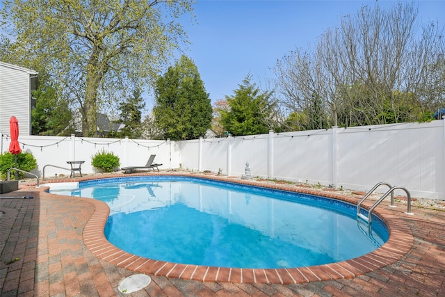 view of pool featuring a fenced in pool, a fenced backyard, and a patio area