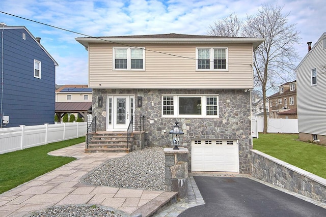 80 Madison Ave, Pleasantville, NY 10570 - colonial-style house with a garage, fence, stone siding, and a front yard