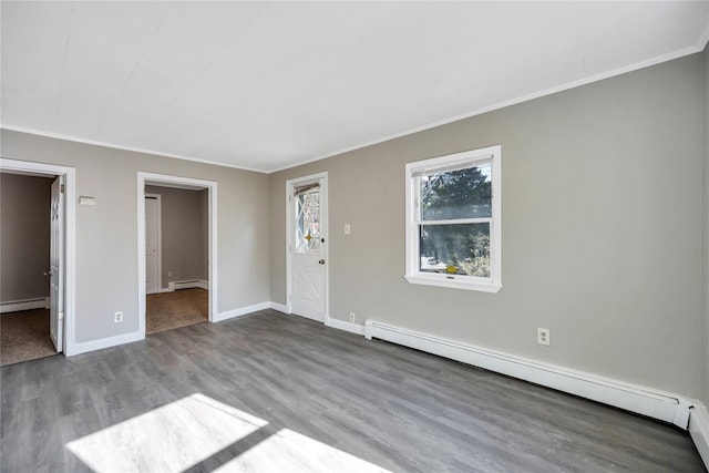 interior space featuring a baseboard heating unit, a baseboard radiator, baseboards, and wood finished floors