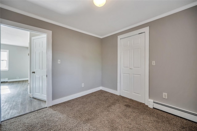 empty room featuring baseboards, ornamental molding, baseboard heating, carpet flooring, and a baseboard heating unit