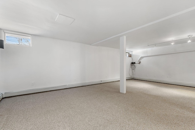 below grade area with carpet and baseboard heating