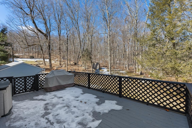 deck featuring grilling area and a view of trees