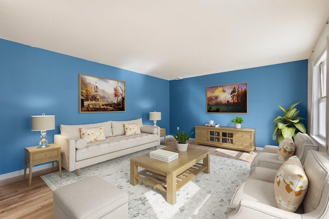 living room with baseboards and light wood finished floors