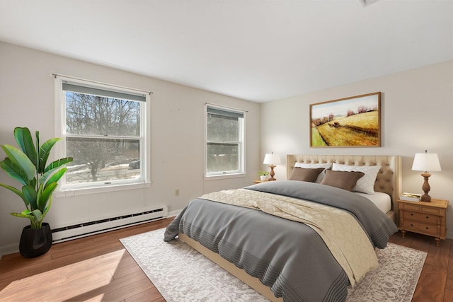 bedroom featuring a baseboard radiator and wood finished floors