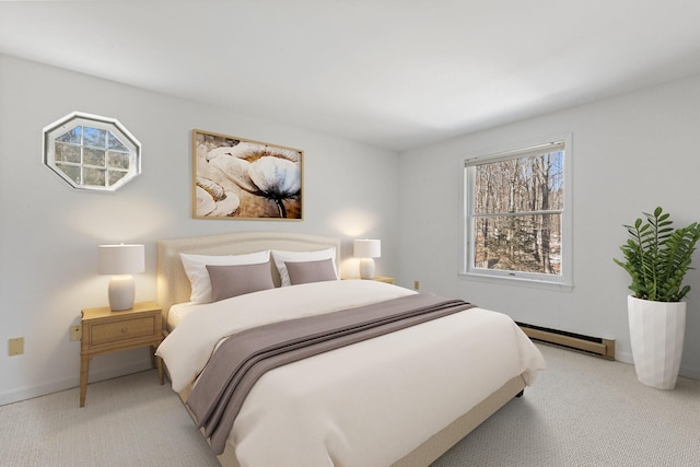 carpeted bedroom with a baseboard heating unit and baseboards