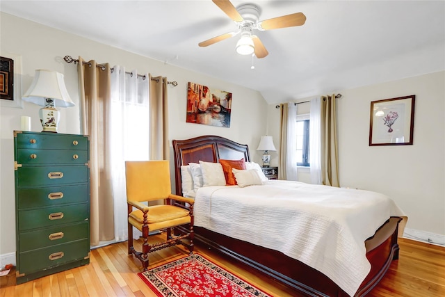 bedroom with hardwood / wood-style flooring, baseboards, and a ceiling fan