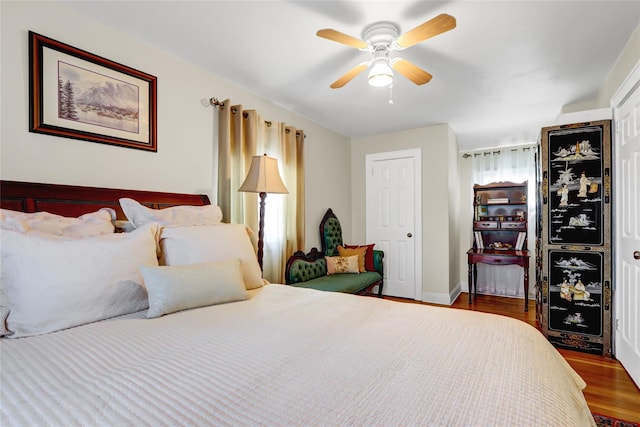 bedroom featuring a ceiling fan and wood finished floors