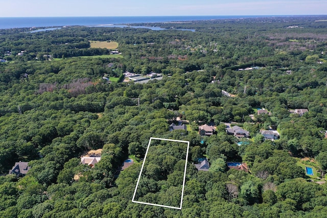 drone / aerial view featuring a wooded view