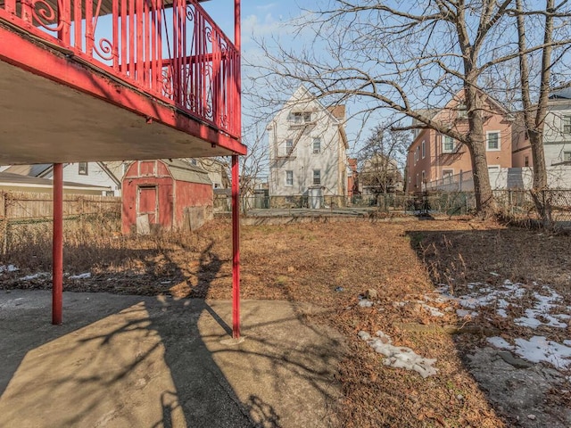 view of yard with a storage unit, an outdoor structure, and fence