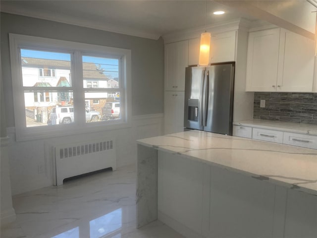 kitchen featuring white cabinetry, marble finish floor, radiator, stainless steel fridge, and pendant lighting