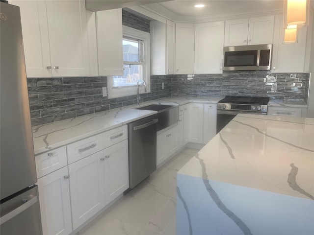 kitchen with stainless steel appliances, marble finish floor, white cabinetry, and light stone counters