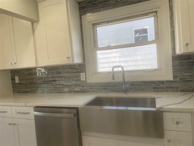 kitchen featuring dishwasher, backsplash, light stone countertops, and white cabinets