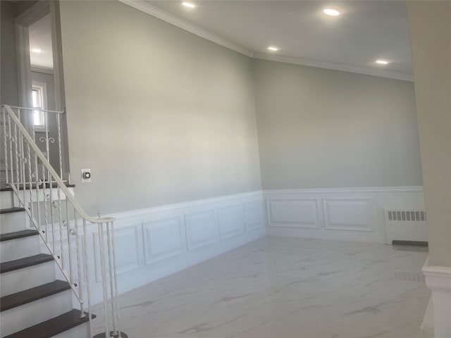 staircase featuring marble finish floor, a wainscoted wall, crown molding, recessed lighting, and radiator heating unit