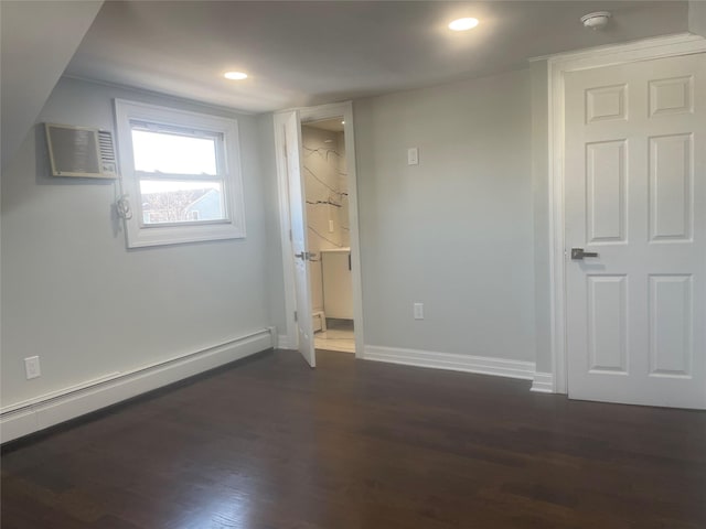 spare room with dark wood-type flooring, a baseboard radiator, baseboards, and recessed lighting