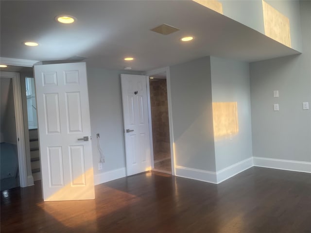 unfurnished room with baseboards, dark wood-style flooring, and recessed lighting