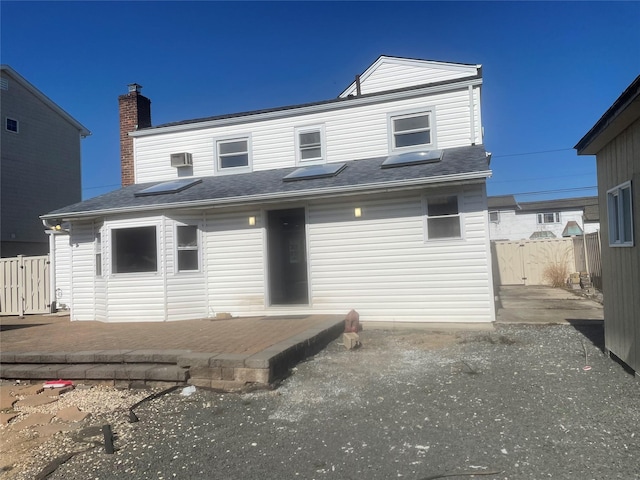 back of house with a patio and fence