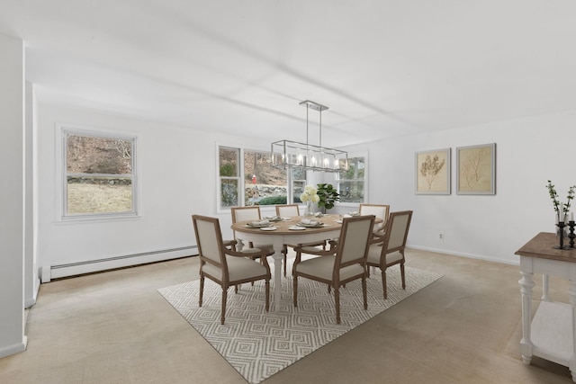 dining room with an inviting chandelier, baseboards, a baseboard heating unit, and light colored carpet