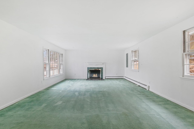 unfurnished living room with a wealth of natural light, baseboards, a fireplace, and carpet