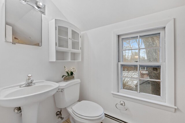 bathroom featuring a baseboard radiator and toilet